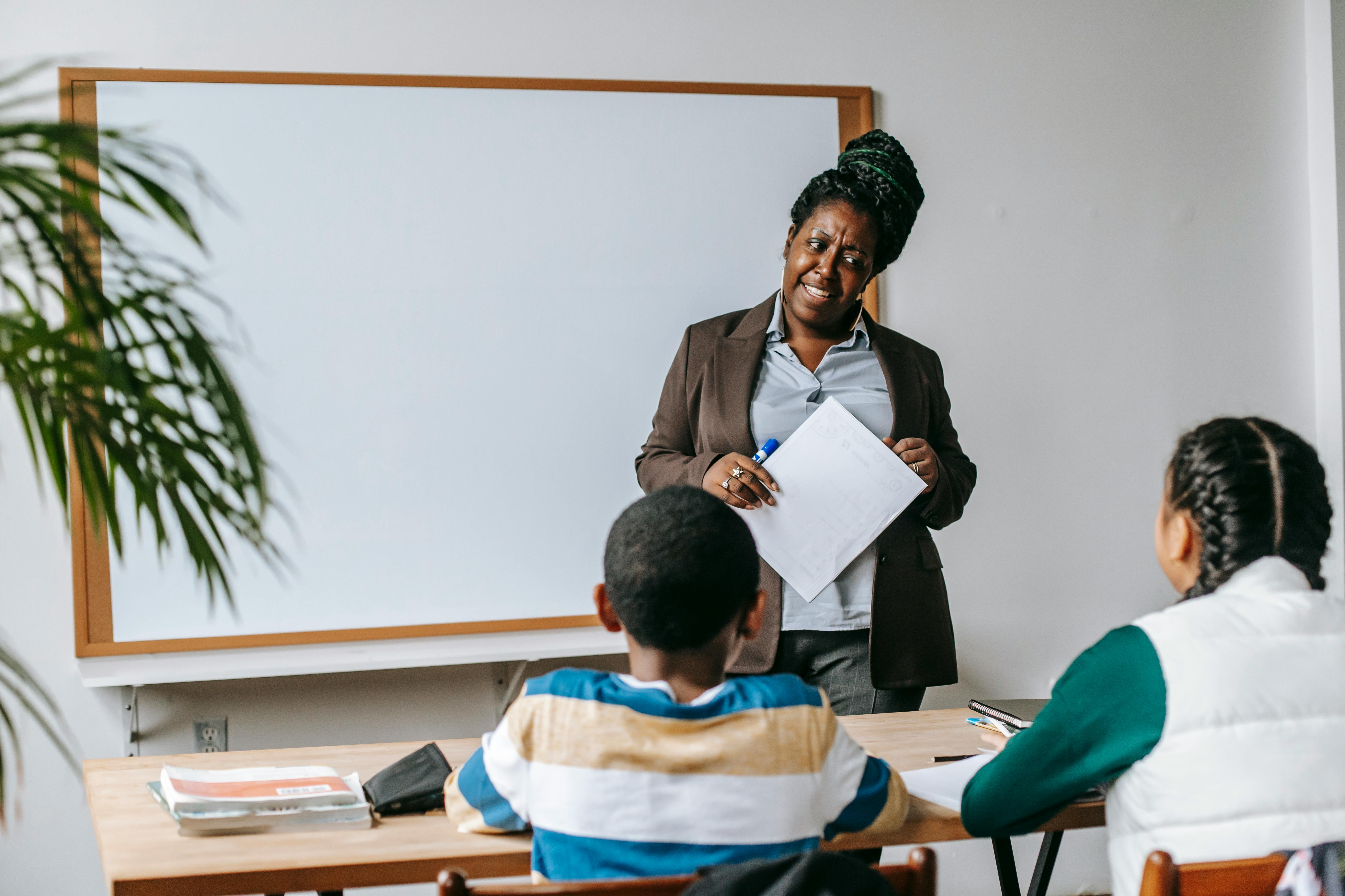 A professional presenting to children in a classroom